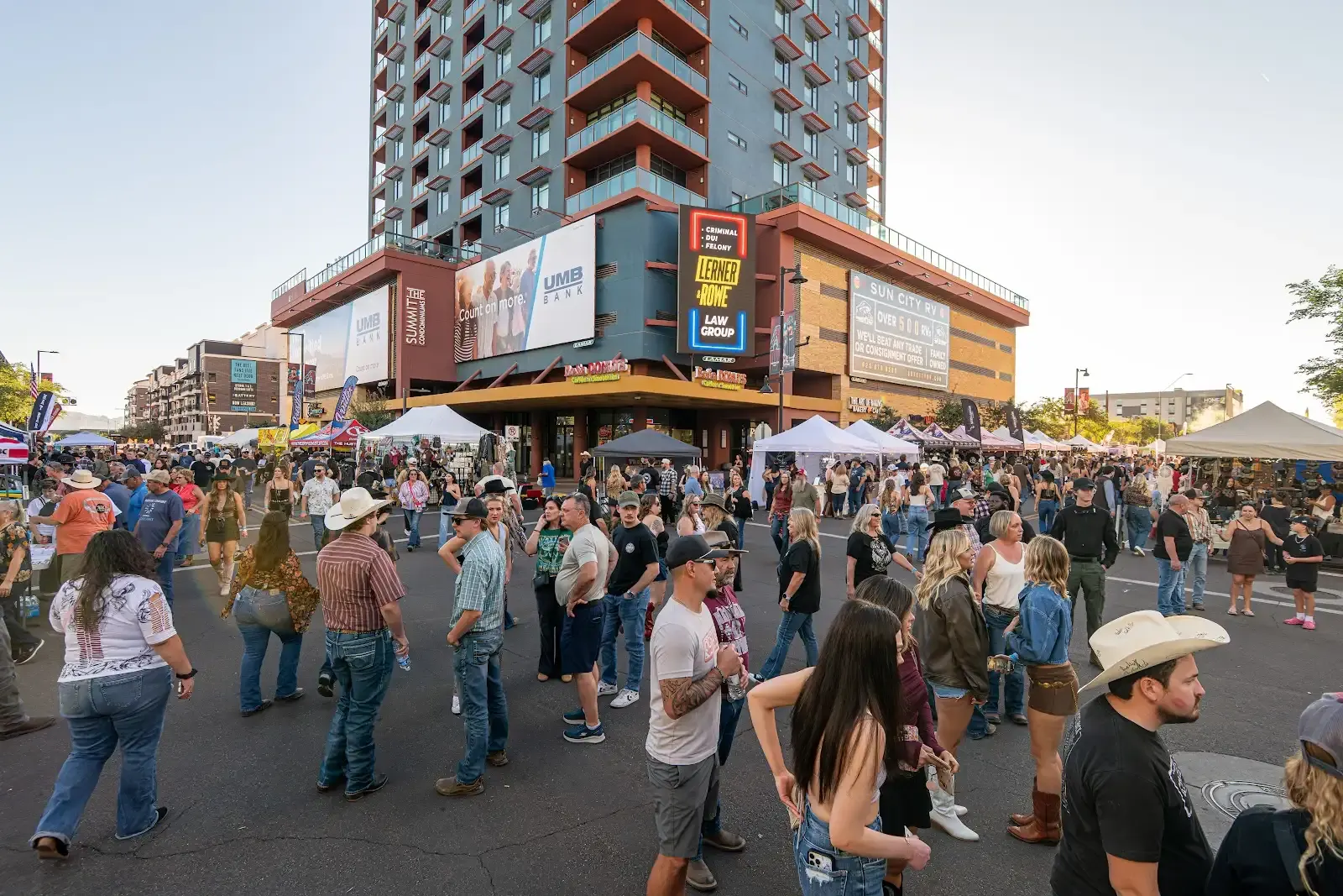 Crowds walking through the Hondo Street Fest outside the stadium