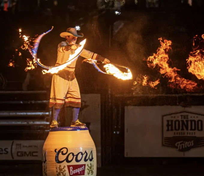 Hondo cowboy statue with fire effects above the arena