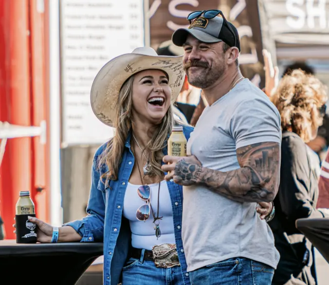Couple laughing together at the Hondo Street Fest