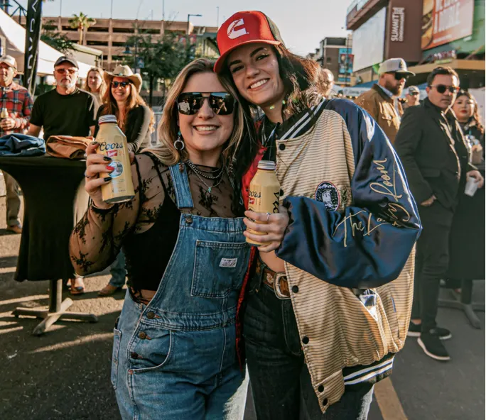 Two fans with drinks at the Hondo Street Fest