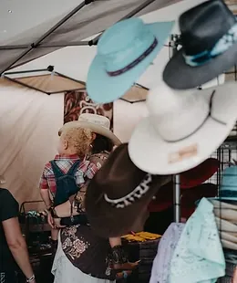 Cowboy hats hanging at a street fest vendor booth