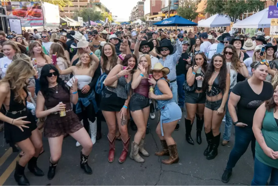 Friends posing together in the street fest crowd